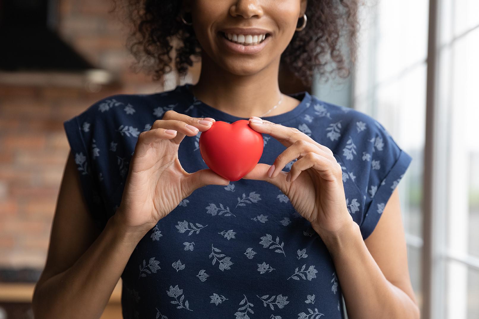 Image of a woman holding a toy heart